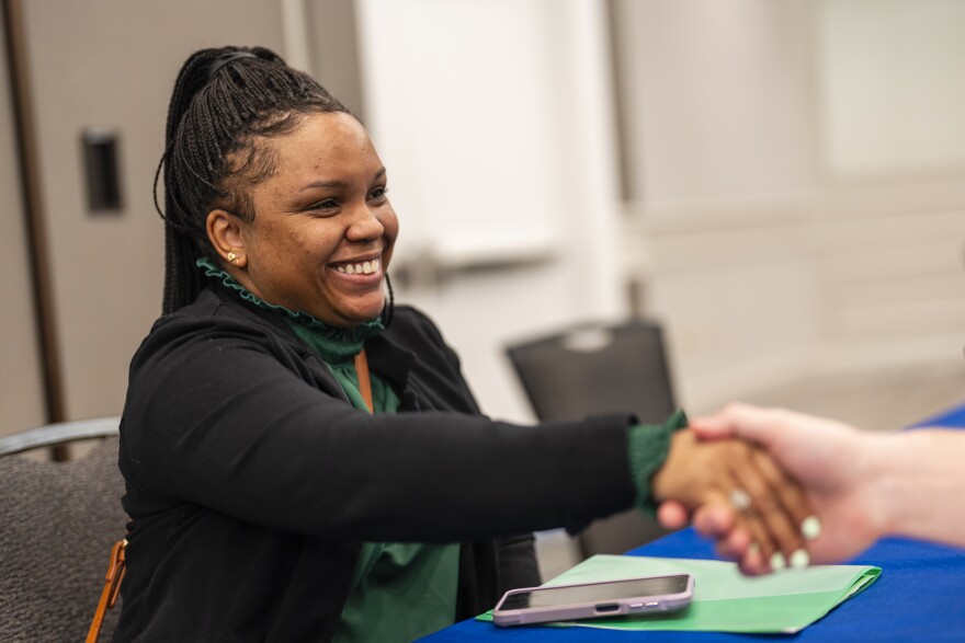 Kandyce Williams, 36, of Cahokia Heights, shakes hands with Michael Bernardy, a human resource specialist at Illinois Department of Children & Family Services (DCFS), after receiving a conditional offer during a hiring event hosted by DCFS on Wednesday, March 27, 2024, at Fountains Conference Center in Fairview Heights. The event drew over 500 people who came to apply for potential work.